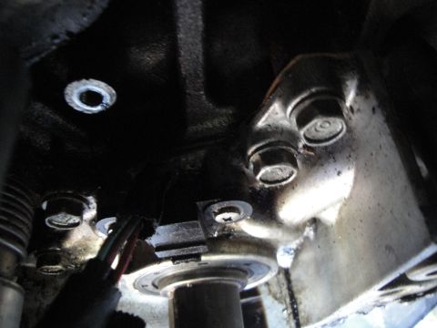 1993 Ford Taurus - A close-up view of an engine component, showing bolts and wiring harness.