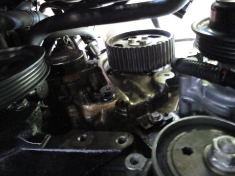 1993 Ford Taurus - Close-up view of an engine's water pump and timing gear assembly.