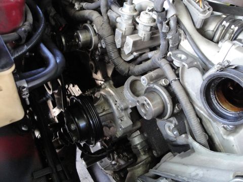 1993 Ford Taurus - Close-up view of an engine's water pump and pulley system.