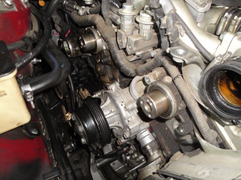 1993 Ford Taurus - Engine water pump assembly with associated belts and hoses visible.