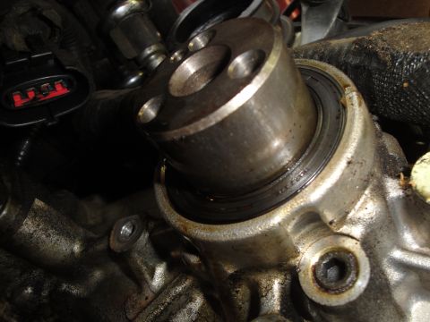 1993 Ford Taurus - A close-up view of a mechanical part within an engine bay, showing metal components and some oil residue.
