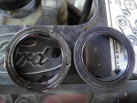 1993 Ford Taurus - Close-up of engine parts, including a Ford-branded component, with visible text on surrounding elements.