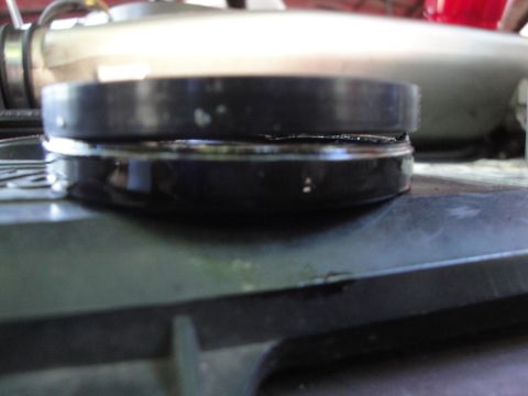1993 Ford Taurus - A close-up view of a black automotive part, possibly a seal or gasket, with a metallic component visible above.