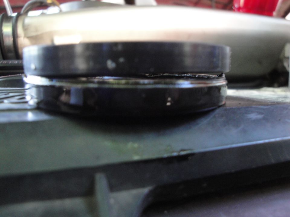 Close-up of a black automotive part with a metallic component