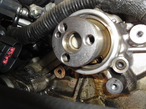 1993 Ford Taurus - A close-up view of an engine's timing component, showing signs of wear and oil residue.