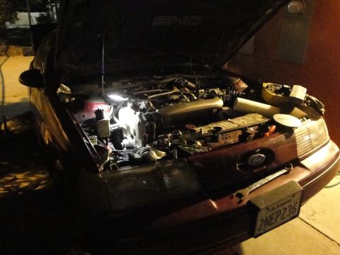 1993 Ford Taurus - Working on the engine of a 1993 Ford Taurus SHO, hood is open.