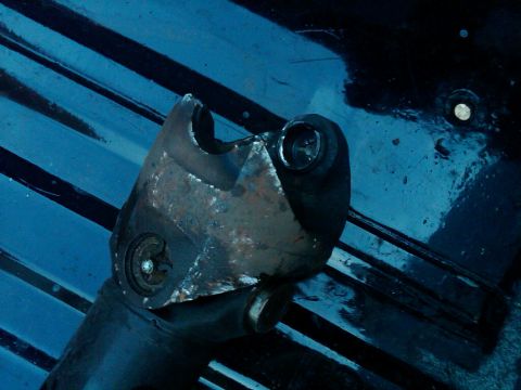 1979 Ford Bronco - Close-up of a worn driveshaft U-joint, showing metal fatigue and a bolt head.