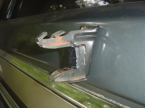 1986 Ford Bronco - Spare tire carrier latch mechanism showing signs of rust and wear.