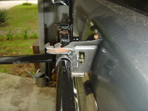 1986 Ford Bronco - Detail of the spare tire carrier bracket, showing its attachment points and mechanism.