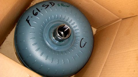 1996 Ford Bronco - A torque converter with handwritten markings is shown inside a cardboard box.