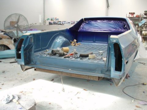1973 Ford Ranchero - The bed of a blue 1973 Ford Ranchero is shown with tools and supplies, suggesting it is undergoing restoration or repair.