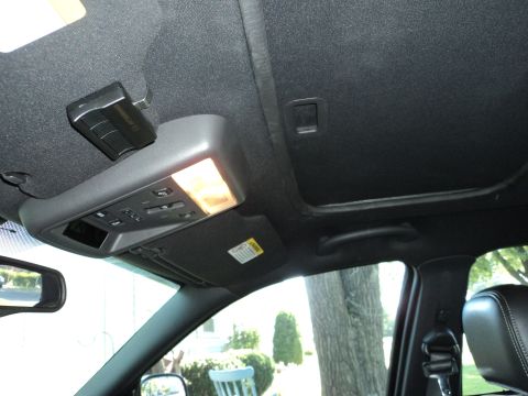 2004 Mercury Grand Marquis - The interior of a 2004 Mercury Grand Marquis, the overhead console with lights and controls, and a sunroof.