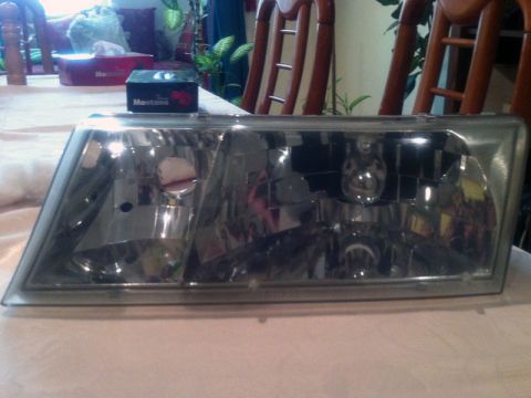 2001 Mercury Grand Marquis - Headlight assembly shown on a table, possibly for restoration or replacement.