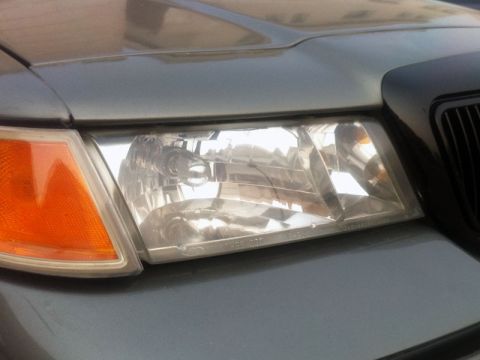 2001 Mercury Grand Marquis - Close-up of the headlight assembly and grille on a 2001 Mercury Grand Marquis.