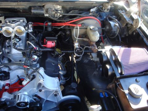 1989 Ford Bronco - Custom engine bay modifications visible, including dual throttle bodies and aftermarket air intake.