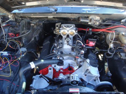 1989 Ford Bronco - The engine bay shows a V8 engine with dual throttle bodies and extensive custom wiring.