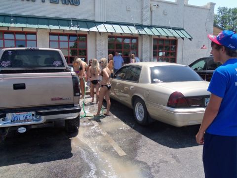 2000 Mercury Grand Marquis - A 2000 Mercury Grand Marquis and a pickup truck are at a car wash with several people.