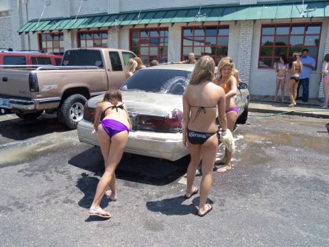 2000 Mercury Grand Marquis - A group of people are washing a 2000 Mercury Grand Marquis at a car wash.