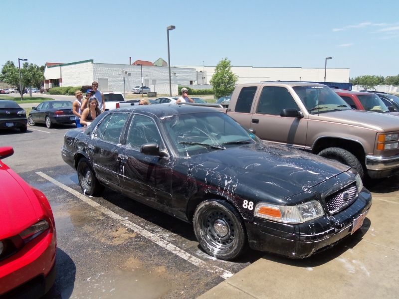 Black sedan with racing number 88, covered in soap