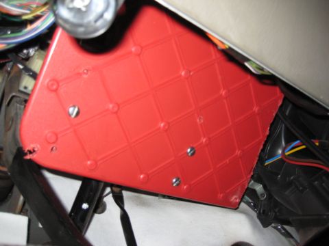 2005 Jeep Wrangler - Close-up of a red dashboard component, possibly from a vehicle's interior.