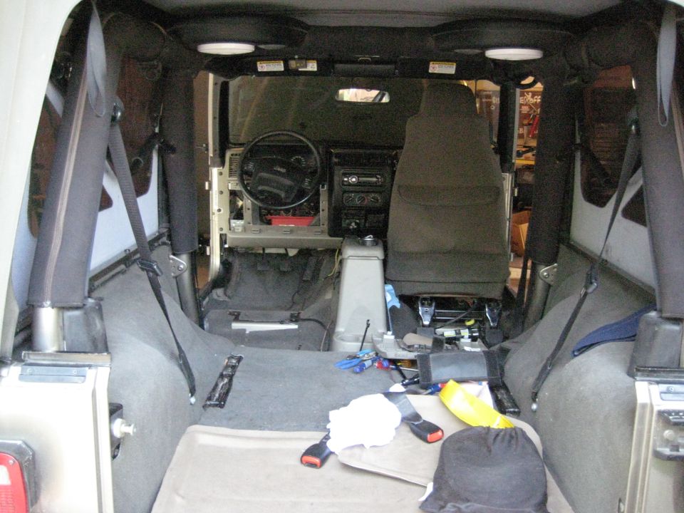 Jeep Wrangler interior from rear with seats out and dash trim removed during stereo install