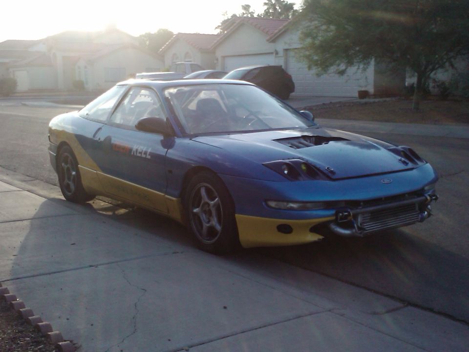 1995 Ford Probe coupe, blue, front-right view, parked on street