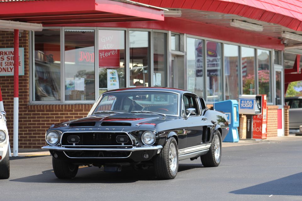 Black 1968 Shelby GT500 parked in front of a restaurant