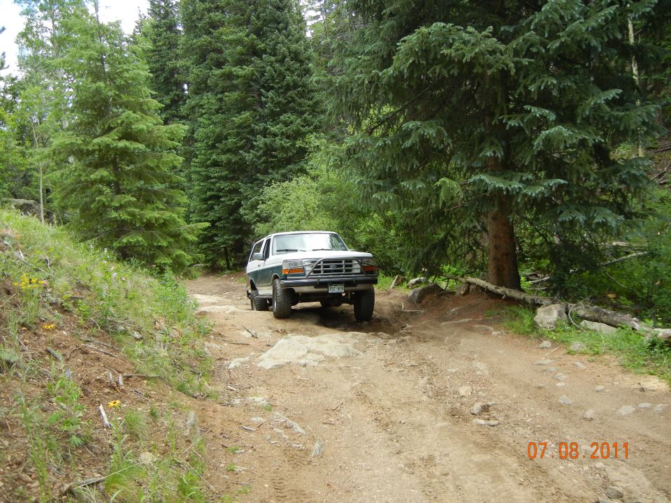 White and green SUV on dirt road, 1992 model year