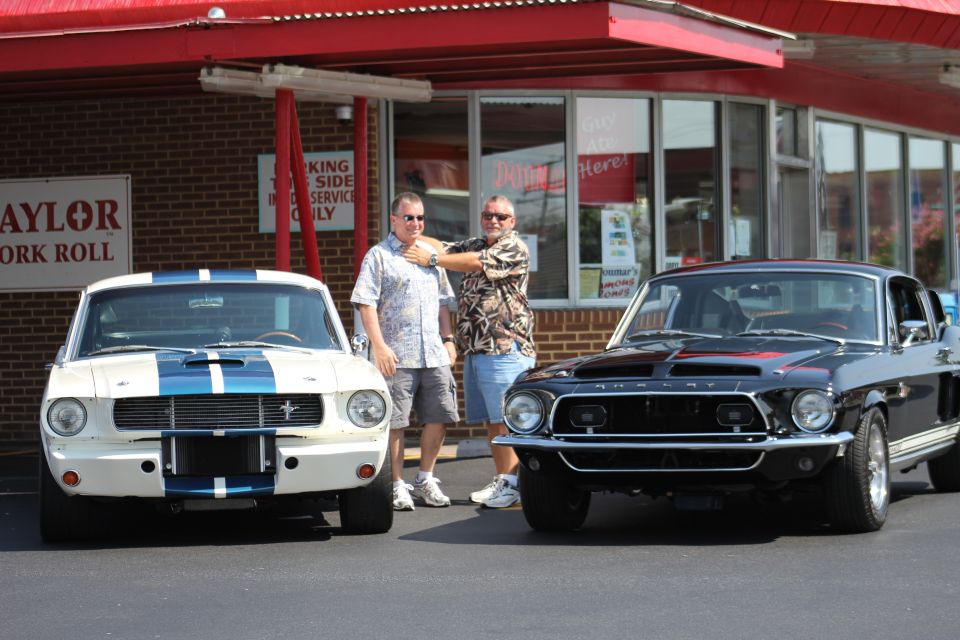Black 1968 Shelby GT500 front view with white 1968 Shelby GT500