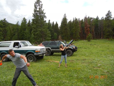 1996 Ford Bronco - A 1996 Ford Bronco is seen in a field with people and another SUV, possibly during an outdoor activity.