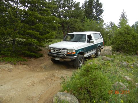 1996 Ford Bronco - This two-tone 1996 Ford Bronco navigates a rocky, wooded trail.