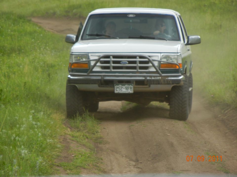 White 1996 Ford Bronco front view on dirt road