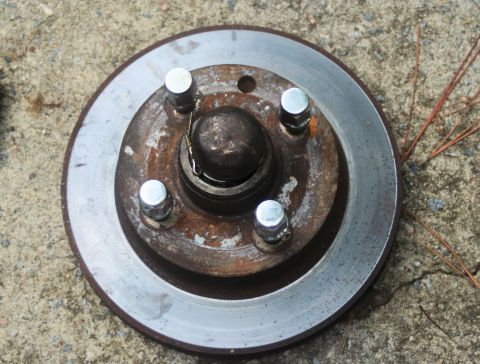1980 Ford Mustang - A close-up view of a used car brake rotor and hub assembly.