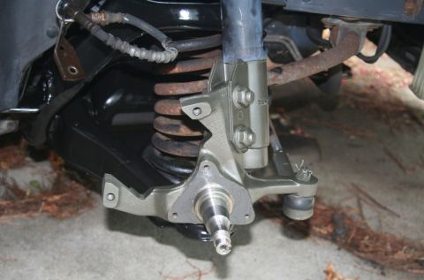 1980 Ford Mustang - This photo shows a close-up view of a vehicle's front suspension system, including the shock absorber and coil spring.