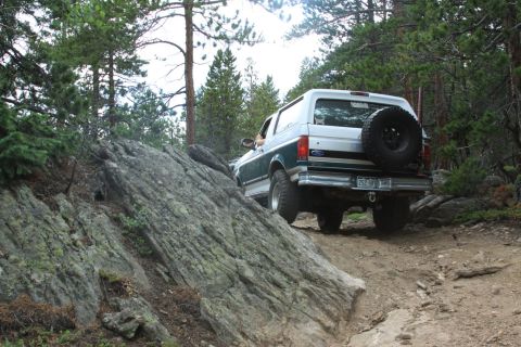 1996 Ford Bronco - This 1996 Ford Bronco navigates a rocky, wooded trail with its rear end facing the camera.