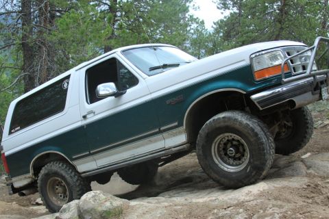 1996 Ford Bronco - This two-tone Ford Bronco is navigating a rocky off-road path.