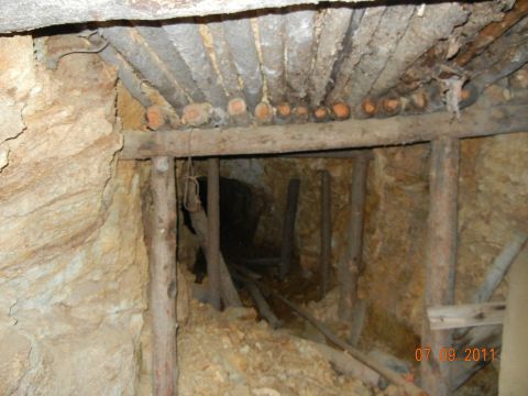 1996 Ford Bronco - The interior of a mine shaft reveals rough-hewn walls and timber supports leading into darkness.
