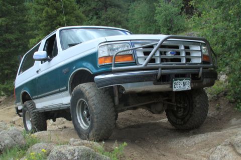 1996 Ford Bronco - This modified Ford Bronco is navigating a rocky, off-road trail.
