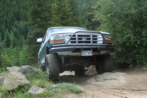 1996 Ford Bronco - This 1996 Ford Bronco navigates a rocky trail with its front end prominently displayed.