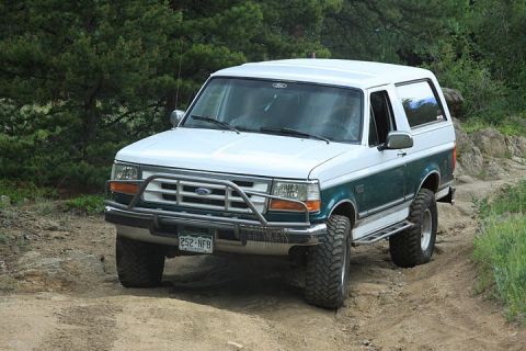 1996 Ford Bronco - This 1996 Ford Bronco is shown on a dirt road, a prominent brush guard on its front end.