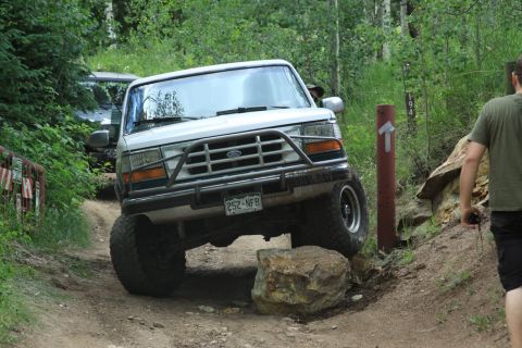 1996 Ford Bronco - This 1996 Ford Bronco is shown off-roading on a rocky trail with another vehicle present.