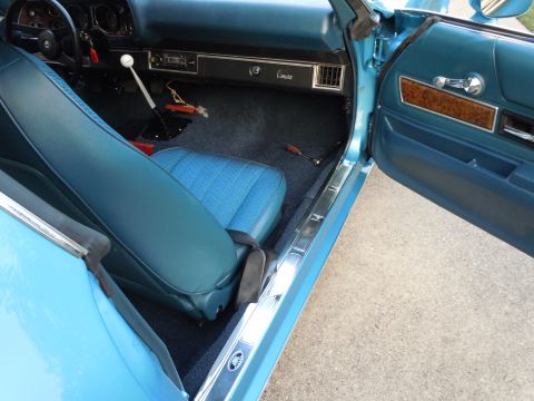 1972 Chevrolet Camaro - The interior of a classic Chevrolet Camaro shows blue vinyl seats and dashboard details.