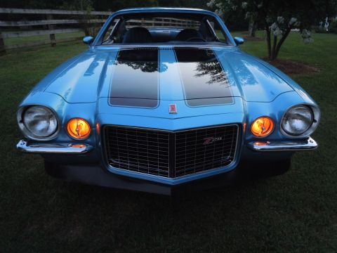 1972 Chevrolet Camaro - Front view of a blue 1972 Chevrolet Camaro Z28 black racing stripes and a chrome grille.