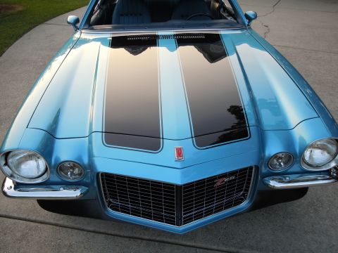 1972 Chevrolet Camaro - A blue Chevrolet Camaro with dual black racing stripes on the hood and a chrome grille is parked on a paved surface.
