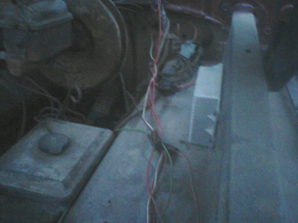 Engine bay with exposed wiring and components