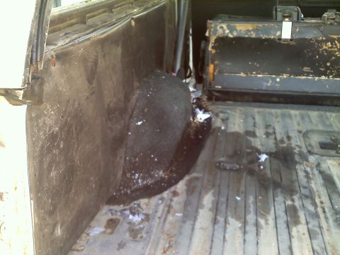 1978 Ford Bronco - The interior cargo area shows signs of wear and tear, with a storage box and a dirty floor visible.