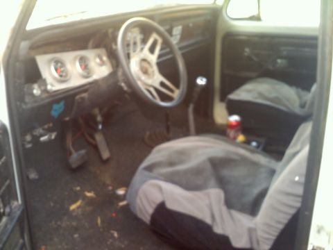 1978 Ford Bronco - Interior view of a vehicle with aftermarket gauges and a steering wheel.
