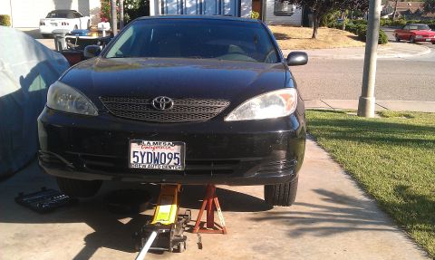 1992 Ford Ranger - A black Toyota Camry is raised on a jack and jack stands in a driveway.