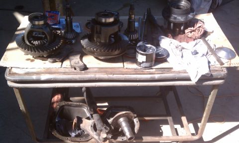 1978 Ford Bronco - Various differential parts are organized on a table, suggesting a repair or rebuild process.