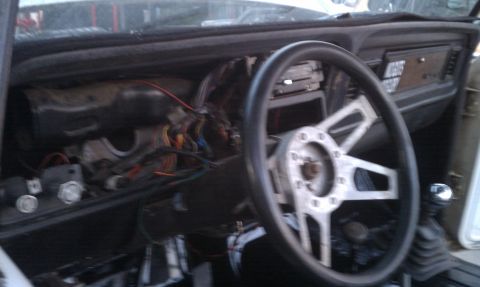 1978 Ford Bronco - The interior of a 1978 Ford Bronco shows exposed wiring and a disassembled dashboard.